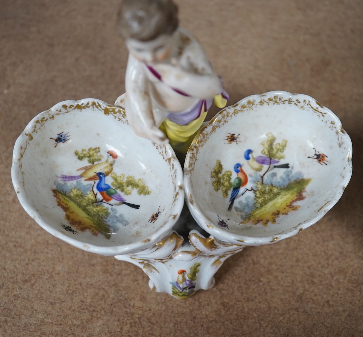 A pair of Berlin figural porcelain salts, hand painted with birds, 13.5cm wide. Condition - fair to good